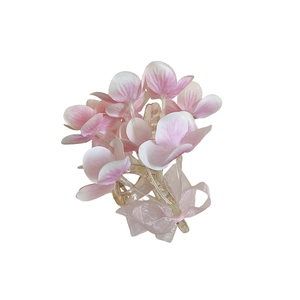 Floral hair claw clip with pink fabric flowers and organza bow for elegant hair styling