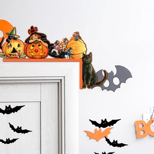 Detail of vintage wooden Halloween door corner decor with witch, pumpkin and bat design