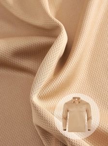 Macro view of breathable khaki knitted polo shirt fabric showing textured mesh structure