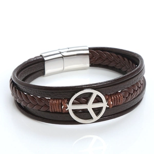 Close-up of brown multilayer leather bracelet with silver peace symbol and magnetic clasp