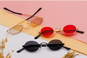 Detailed view of three vintage oval metal sunglasses with colorful ocean resin lenses
