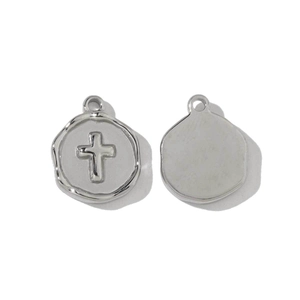 Detailed macro view of silver stainless steel cross pendant showing front and back texture
