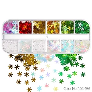 Macro detail of 12-grid Christmas snowflake nail art glitter sequins in various colors
