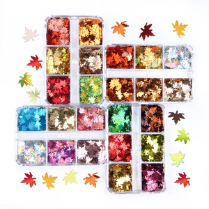 6-grid box of holographic 6mm maple leaf nail sequins in vibrant autumn colors