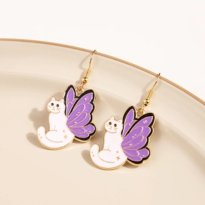 Detail of creative cat earrings with purple butterfly wings and gold finish