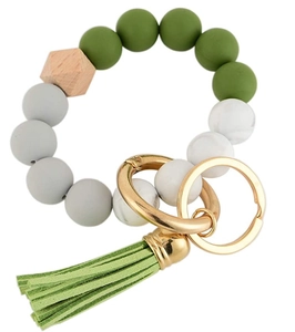Detail of beaded keychain with green silicone beads, wooden bead and soft green tassel