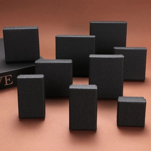 Multiple sizes of matte black jewelry gift boxes with refined litchi grain texture