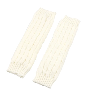 Close-up of cream knit leg warmers with cable stitch texture and ribbed cuffs