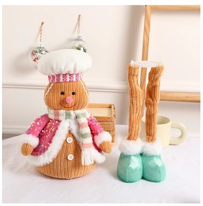 Detail of a Christmas gingerbread man plush toy with telescopic legs and sequin clothing