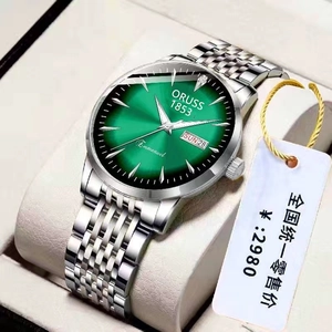 Detail of green sunray dial business watch with steel strap and double calendar display
