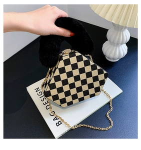 Detail of hexagonal checkerboard bag with plush faux fur handle and gold chain strap
