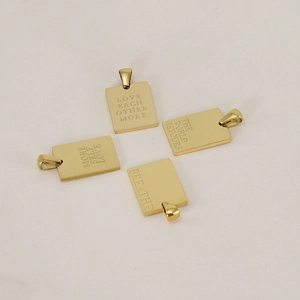 Detailed view of four gold rectangular pendants with unique engraved English quotes