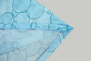 Detailed macro view of blue geometric print fabric with breathable mesh texture and seams