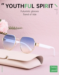 Detail of gold metal octagon sunglasses with gradient lenses and beige leather case