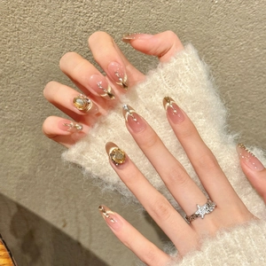 Luxury nude pink gradient press-on nails with champagne rhinestones and golden accents