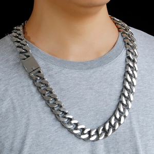 Macro view of silver curb chain link necklace featuring a bold industrial toggle clasp
