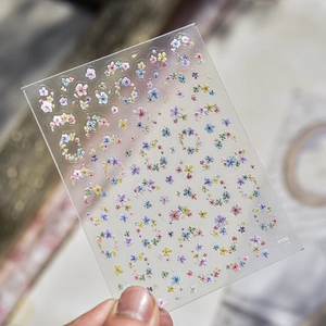 Detail of 3D embossed French floral nail art sticker sheet with colorful flower patterns