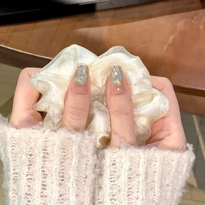 Press-on nails with blue-green shell fragments, silver glitter, and pearl accents