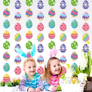 Colorful Easter egg hanging decorations with kids in bunny ears and festive spring props