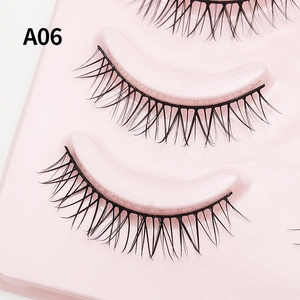 Macro shot of A06 black natural false eyelashes on a pink display tray for daily makeup