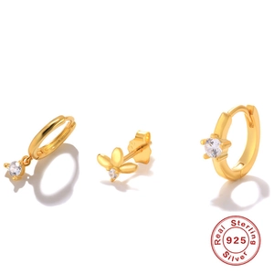 Detailed macro view of 925 sterling silver earring set with gold finish and zircon stones