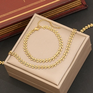 Detail view of a gold leaf chain bracelet with lobster clasp on a jewelry box