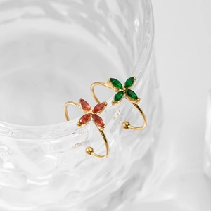 Gold lucky four-leaf clover open rings with colorful zircon on a glass edge