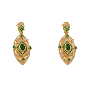Vintage gold oval earrings featuring large green gemstones and white crystal accents