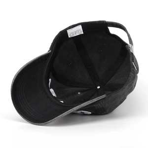Detail view of cotton baseball cap interior showing 100% cotton label and adjustable strap