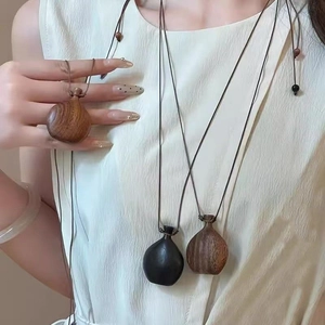 Bohemian wood bottle pendant necklace on wax cord for a minimalist vintage look