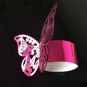 Laser-cut butterfly napkin ring in metallic fuchsia paper with intricate openwork pattern