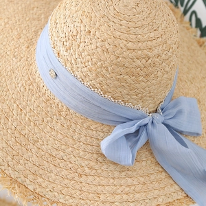 French woven raffia sun hat for women featuring a blue lace ribbon and vintage buckle