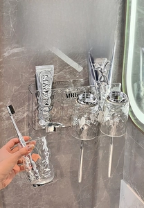 Detail of glacier texture toothbrush holder with wall-mounted cup in a modern bathroom