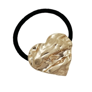 Minimalist heart-shaped gold alloy hair tie with textured finish on black elastic band