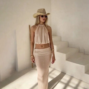 Women's chic champagne knit set featuring halter crop top and slim maxi skirt