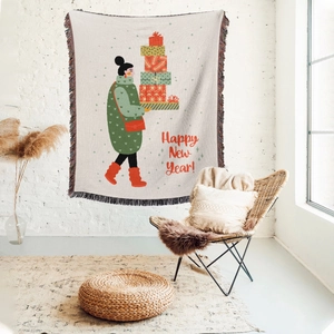 Detail of bohemian Christmas throw blanket featuring woman with gifts and fringe edges