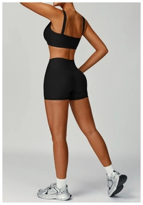 Detail of black ribbed seamless yoga bra and high waist shorts with flattering cut