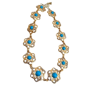 Vintage gold hollow flower necklace with turquoise blue gemstones and sparkling crystals