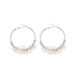 Silver hoop earrings featuring acrylic floral charms and beads on a clean white background