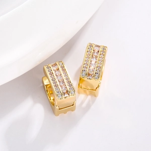 Minimalist square gold earrings with micro-paved cubic zirconia on a white surface