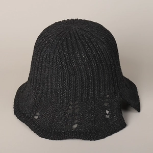 Detail of black knit bucket hat with lace cutout brim and elegant rear bow design