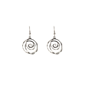 Close-up of silver bohemian spiral earrings with elegant hollowed artistic details