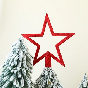 Close-up of a red glitter star Christmas tree topper with hollowed out sparkling pattern