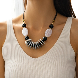 Close-up of model wearing a vintage layered acrylic pendant necklace with leather cord
