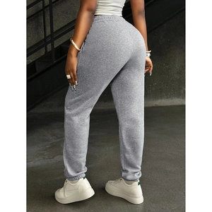 Women's gray cotton sweatpants featuring drawstring elastic waist and cinched cuffs