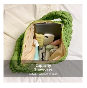 Interior view of the green quilted cloud bag showing large capacity for daily essentials