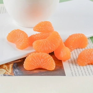 Realistic orange slice PVC model ornaments with textured fruit pulp details on white tray