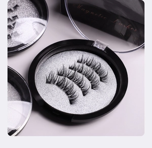 Detail of multi-pair magnetic lashes in a black round storage box with silver glitter base