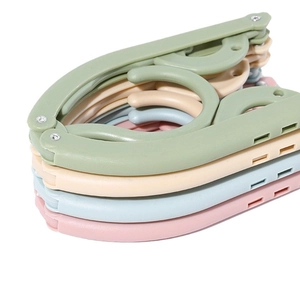 Set of 4 portable folding plastic hangers in pastel colors for travel and home use