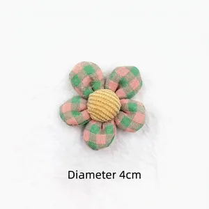 Detail of 4cm plaid fabric five-petal flower accessory with a yellow corduroy center